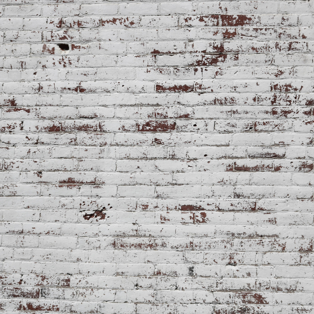 Red brick wall roughly painted white